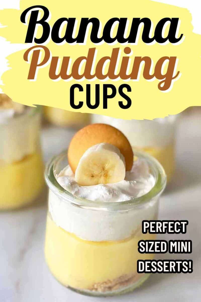 A small glass cup filled with banana pudding, topped with whipped cream, a banana slice, and a cookie. The text reads, Banana Pudding Cups and Perfect Sized Mini Desserts! The background shows blurred similar cups.
