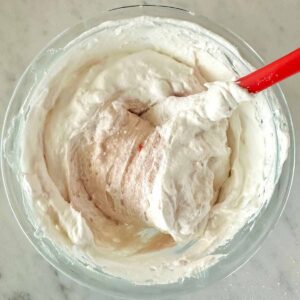 Folding whipped topping into the cheesecake dip