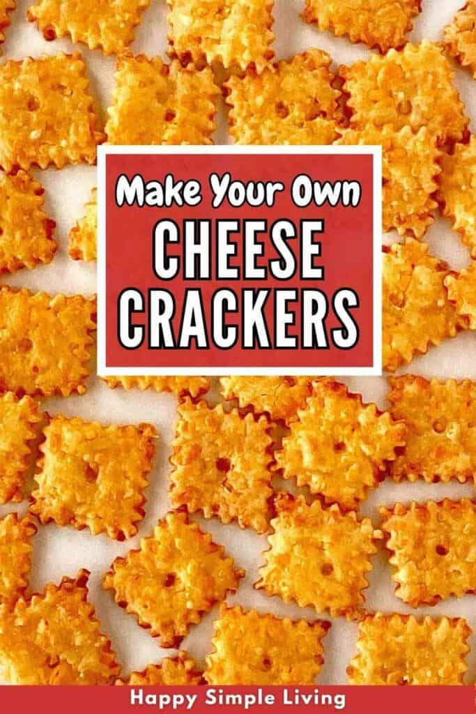 A close-up of homemade square cheese crackers arranged neatly. In the center is a red box with the text Make Your Own Cheese Crackers. A red banner at the bottom reads Happy Simple Living.