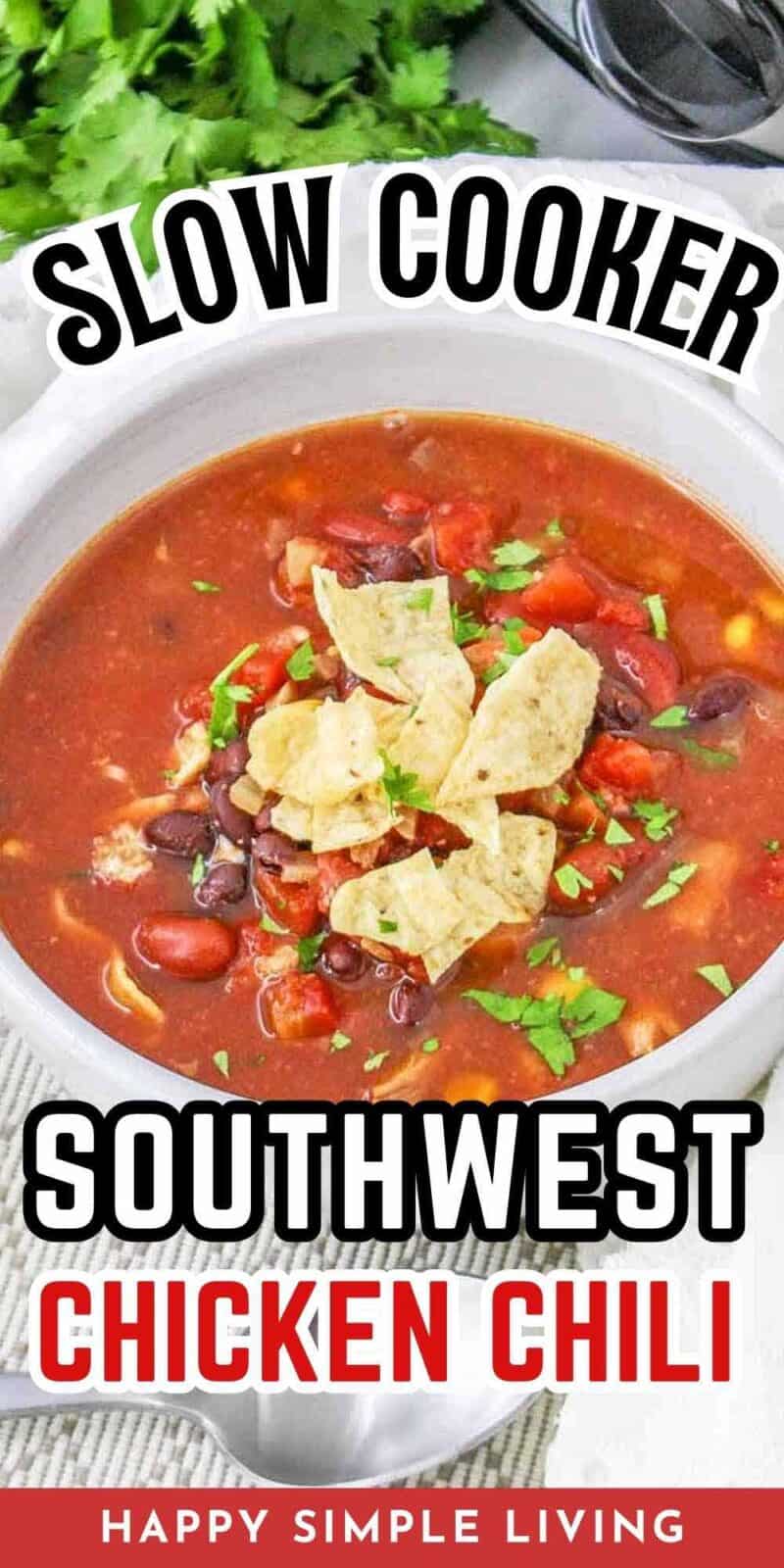 A white bowl filled with southwest chicken chili, topped with crumbled tortilla chips.